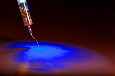 a needle syringe containing metals and unknown substances related to the controversy about vaccine safetyの写真素材