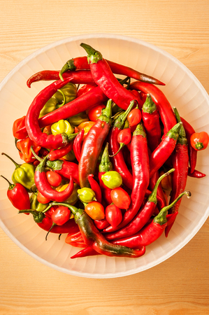 mixt of chili pepper in a white basketの写真素材