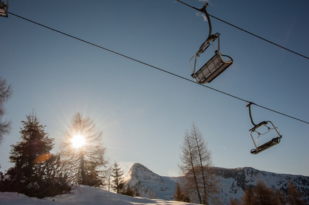 chair lifts with snow-capped dolomites in the backgroundの写真素材