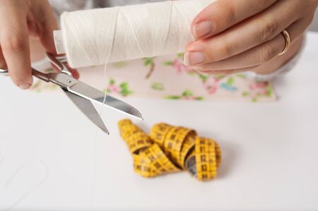 handkerchiefs cut the thread with scissorsの写真素材