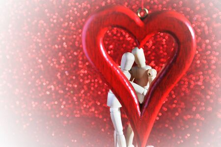 mannequins in love, playing with a wooden heartの写真素材
