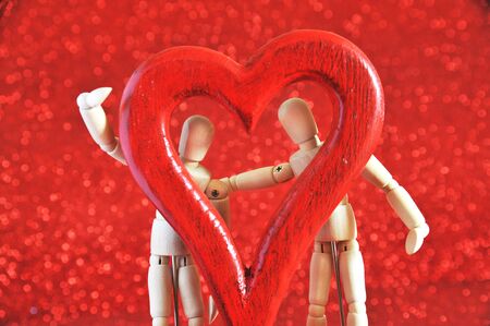 mannequins in love, playing with a wooden heartの写真素材