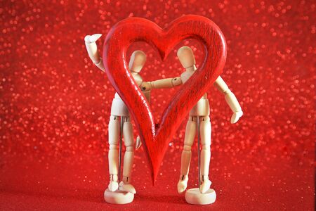 mannequins in love, playing with a wooden heartの写真素材