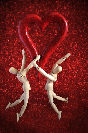 mannequins in love, playing with a wooden heartの写真素材