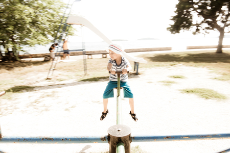 child on an old rotating carouselの写真素材