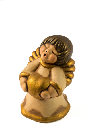 Little gold angel with a big hearthの写真素材