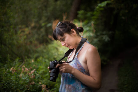 Nice girl watching photos taken in the cameraのeditorial素材