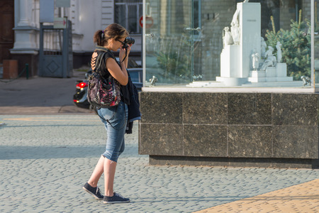 Nice girl shooting photos around the squareのeditorial素材