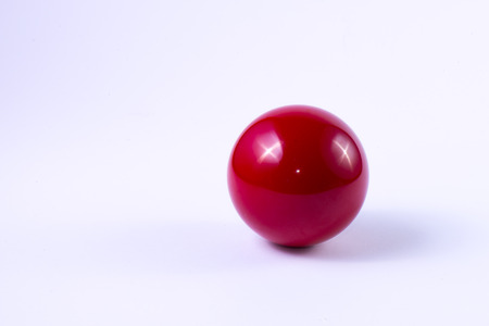 A red billard ball on white backgroundの写真素材