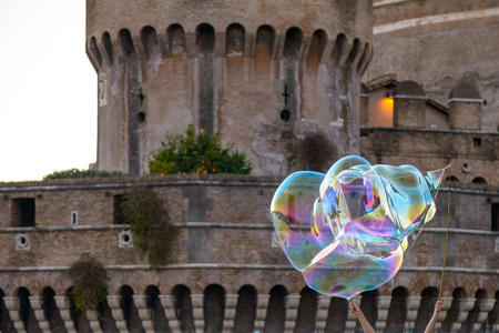 Colorful soap bubbles and the vatican in background (castel sant'angelo)の写真素材