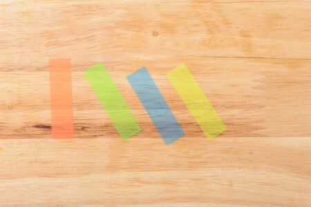 notes four colours in vertical and diagonal on wood backgroundの写真素材
