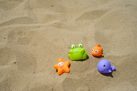 funny and colorful plastic toys on the beachの写真素材