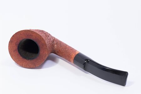a beautiful briar pipe with a black mouthpiece on a white backgroundの写真素材