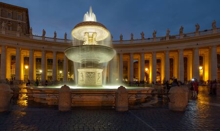 A wonderful fountain in Saint Peter square during the sunset.の写真素材