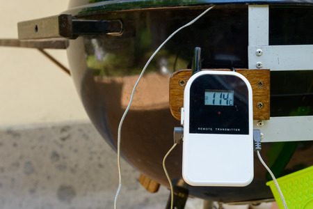 A thermometer for indirect cooking attached to a barbecueの写真素材