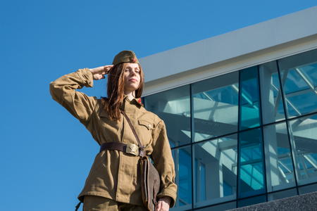 A girl in soviet uniform posing in Constitution square in Kharkiv, Ukraineの写真素材