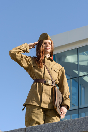 A girl in soviet uniform posing in Constitution square in Kharkiv, Ukraineの写真素材