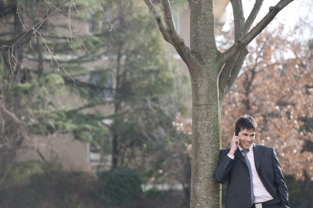 Businessman on the phone outdoorsの写真素材