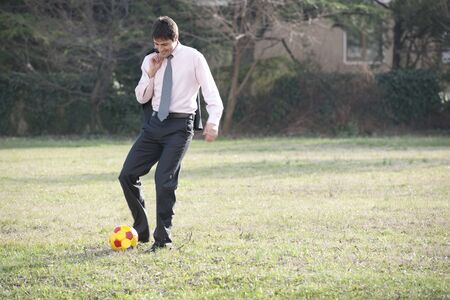 Businessman playing soccer/footballの写真素材