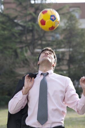 Businessman playing soccer/footballの写真素材