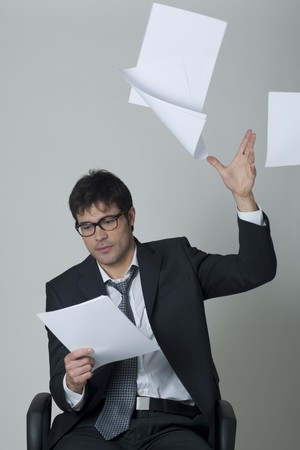 Businessman throwing documents away!の写真素材