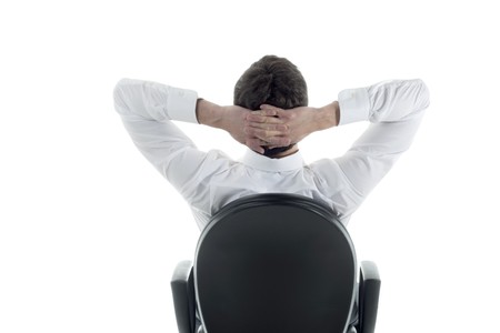 Rear viwe of a relaxed businessman with hands behind his head