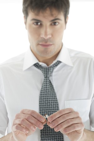 Businessman braking cigarettes. Concept: give up smoking. Focus on foreground.の写真素材