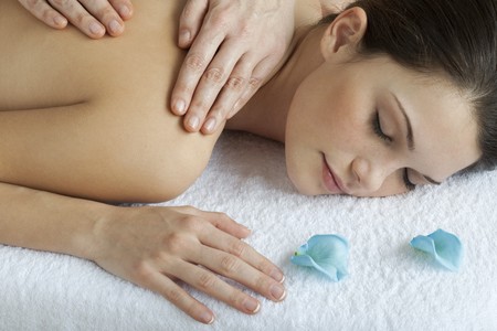 Beautiful relaxed woman receiving back massage with oiの写真素材