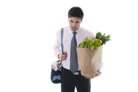 Exhausted man with diaper bag and shopping bagの写真素材