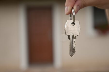 Woman holding the key of her new houseの写真素材