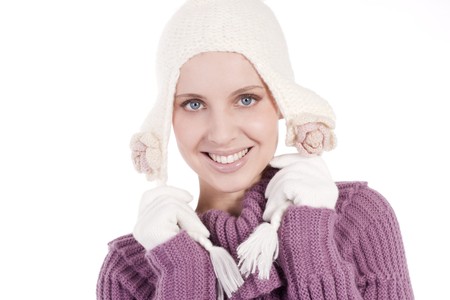 Beautiful young woman in soft sweater, cap and mittens, isolated on whiteの写真素材