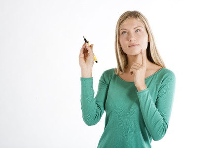 Beautiful young woman with pen, isolated on whiteの写真素材