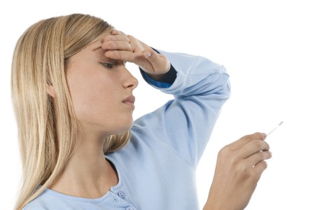 Young woman with temperature and flu