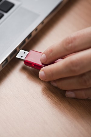 Inserting a usb drive into a laptop computerの写真素材