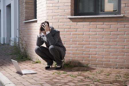 Tired businesswoman with headache or problemsの写真素材