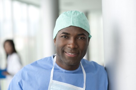 Portrait of a male surgeon, colleagues on backgroundの写真素材
