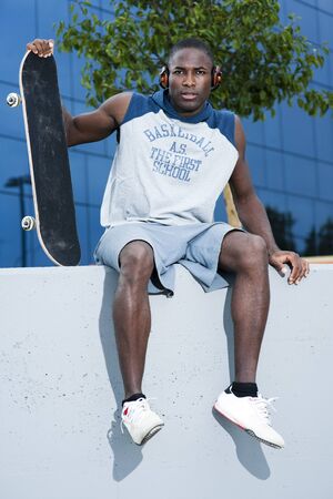 Young skateboarder taking a restの写真素材