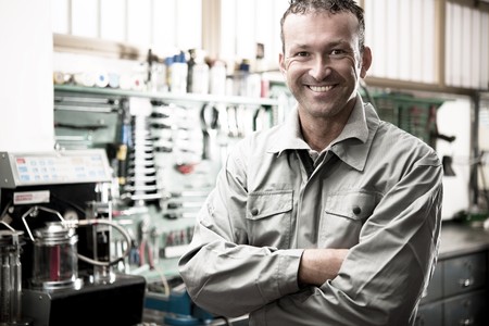 Close-up of a smiling mechanic inside his auto repair shopの写真素材