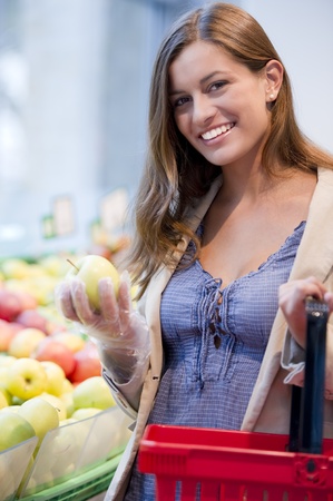 Young woman shopping at supermarketの写真素材