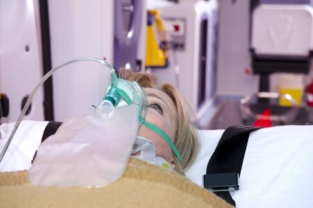 Injured Woman With Oxygen Mask, ambulance interiorの写真素材