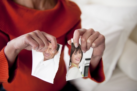 Woman Tearing Photograph of Her Relationshipの写真素材