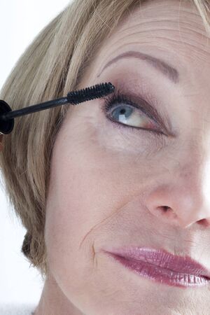 Mature Woman Applying Mascaraの写真素材