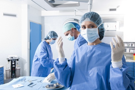 Portrait of a female surgeon, operation in the backgroundの写真素材