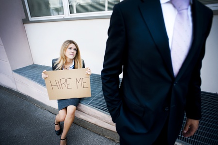 Young woman asking for a job, man looking indifferentの写真素材