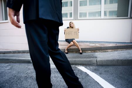 Young woman asking for a job, man looking indifferentの写真素材