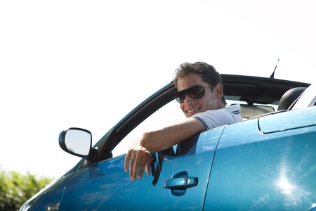 Side view of a man driving his convertible carの写真素材