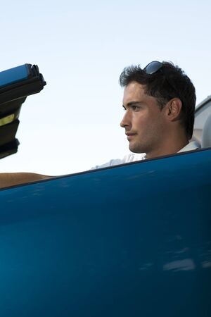 Low angle view of a man driving his convertible car