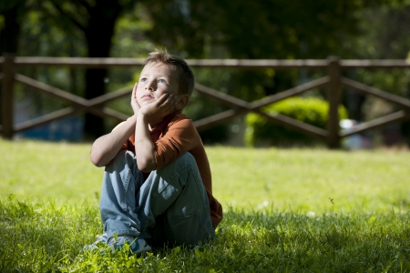 Little boy deep in thoughtsの写真素材