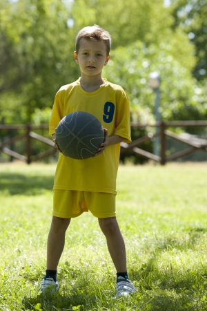 Portrait of a little boy holding a basketballの写真素材