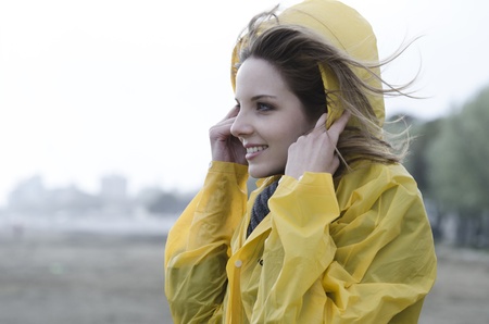 Young woman enjoying a windy day on he beachの写真素材